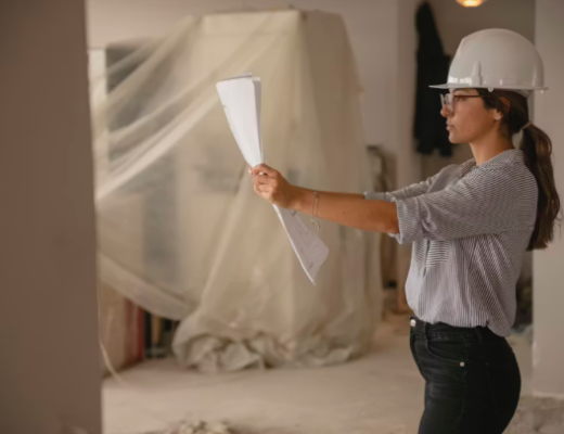 Woman Wearing a Hardhat in a Commercial Office Building Under Construction
